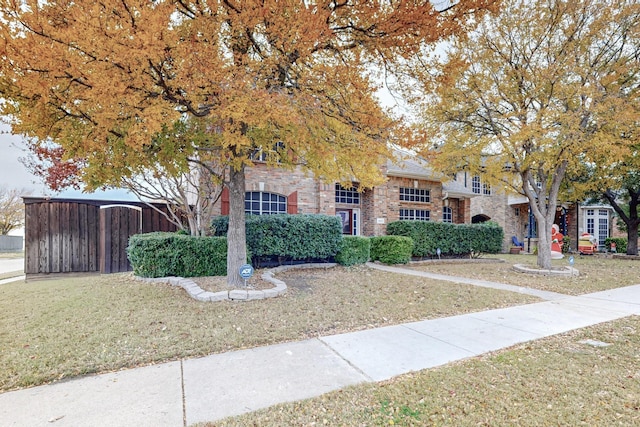 obstructed view of property with a front yard