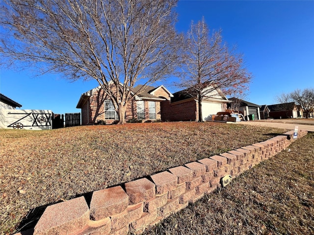 single story home featuring a garage and a front yard