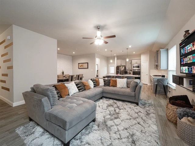 living room with ceiling fan and hardwood / wood-style floors