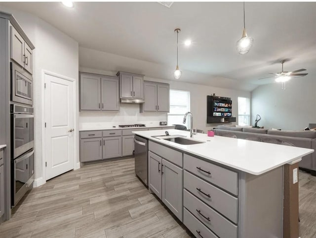 kitchen with gray cabinetry, sink, and stainless steel appliances