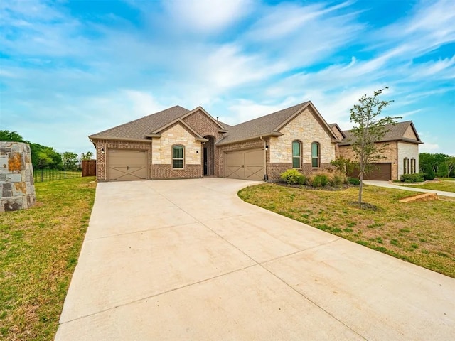 view of front of home with a garage and a front lawn