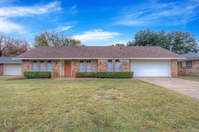 ranch-style home featuring a front yard and a garage