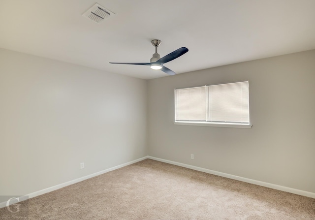 spare room with light carpet and ceiling fan