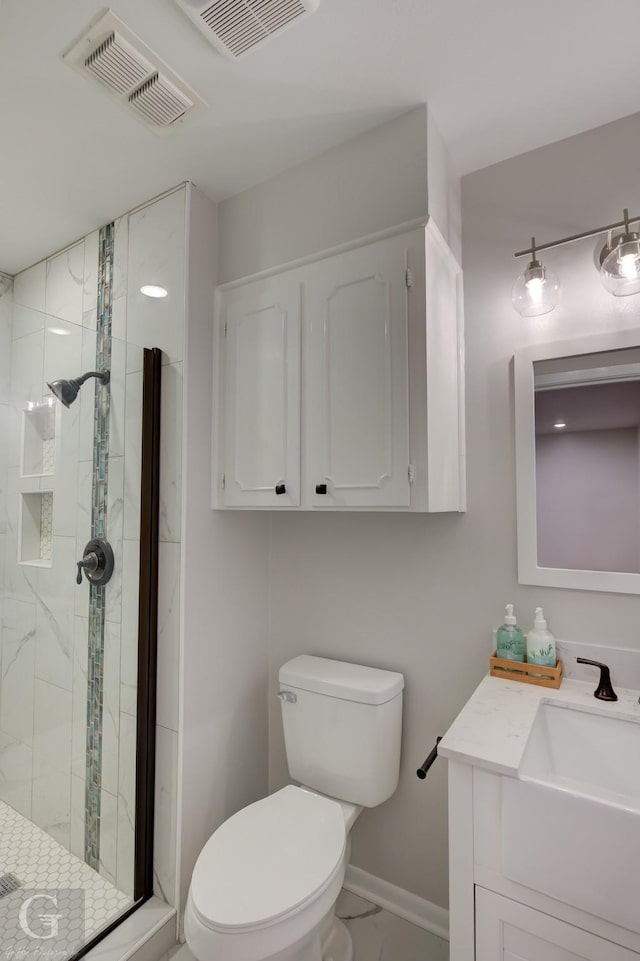 bathroom with vanity, an enclosed shower, and toilet