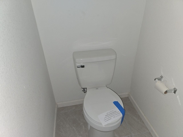 bathroom featuring tile patterned flooring and toilet