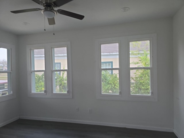 unfurnished room featuring ceiling fan and dark wood-type flooring