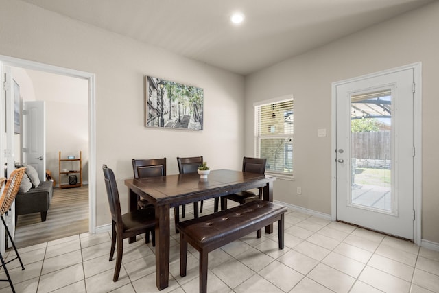 dining space featuring light tile patterned flooring