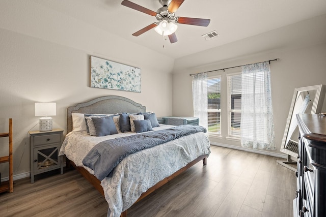 bedroom with dark hardwood / wood-style flooring and ceiling fan