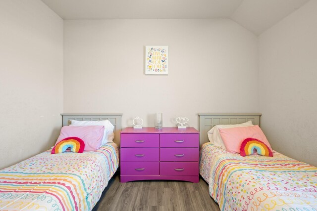 bedroom featuring dark hardwood / wood-style floors and lofted ceiling