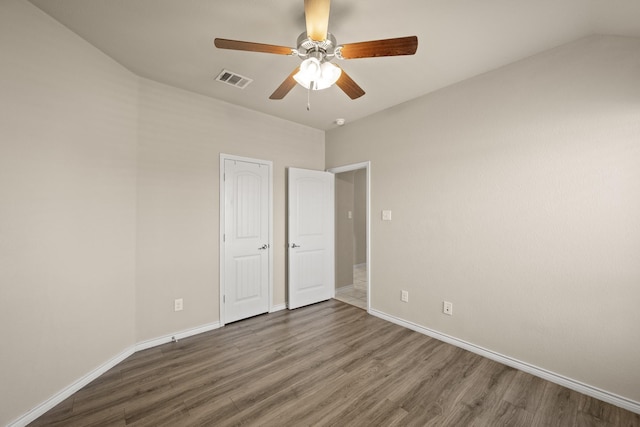 unfurnished bedroom with dark hardwood / wood-style floors and ceiling fan