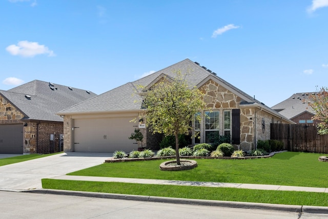 view of front of home with a front yard and a garage