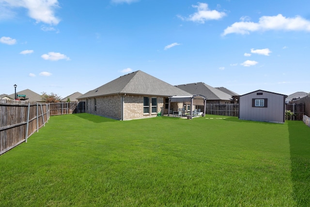 back of house with a lawn and a shed