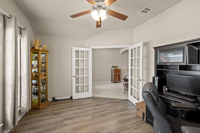 office space featuring hardwood / wood-style floors, ceiling fan, lofted ceiling, and french doors