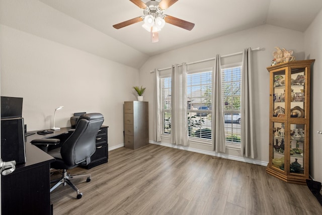 office area with light hardwood / wood-style floors, vaulted ceiling, and ceiling fan