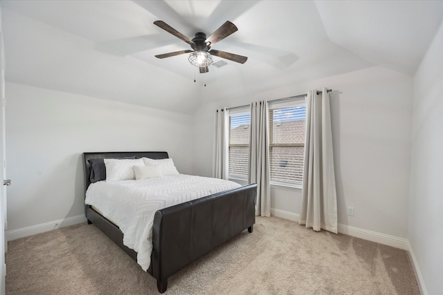 carpeted bedroom with ceiling fan and vaulted ceiling