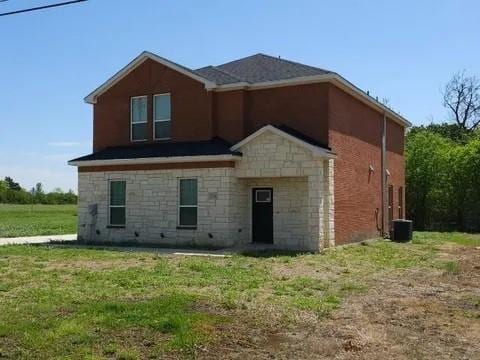 rear view of property with a yard