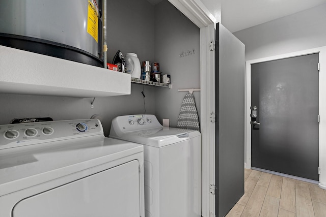 washroom with washer and dryer and light hardwood / wood-style floors