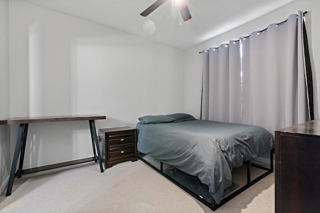 bedroom with ceiling fan and light carpet