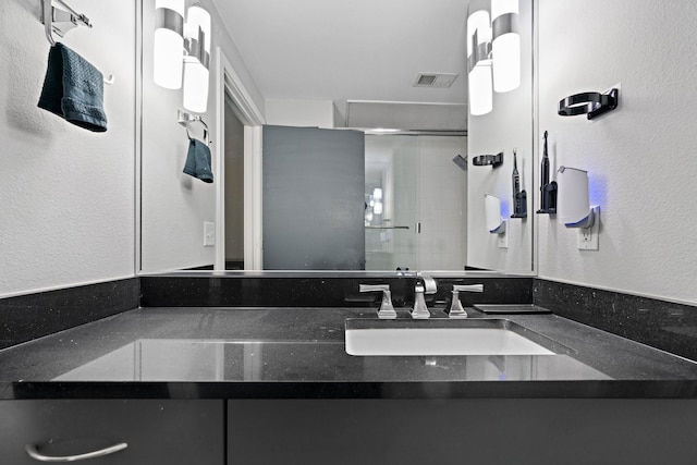 bathroom with vanity and walk in shower