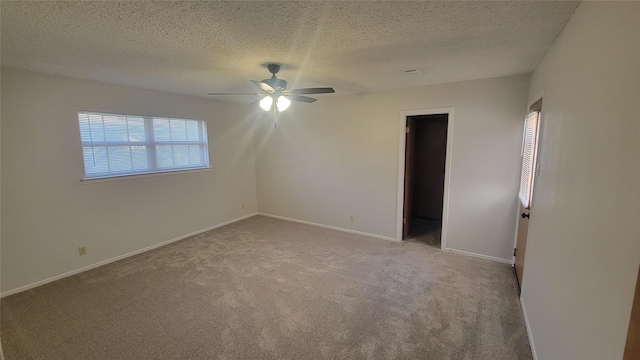 unfurnished room with light carpet, a textured ceiling, and ceiling fan