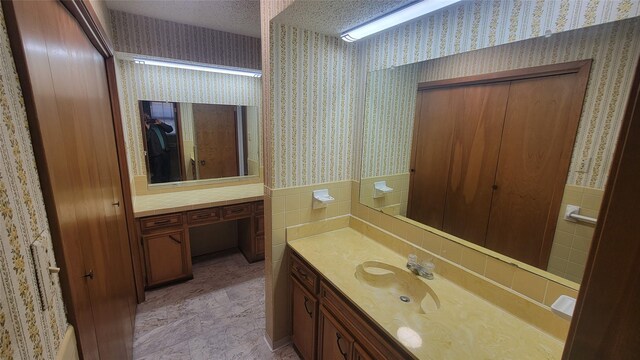 bathroom with vanity and a textured ceiling