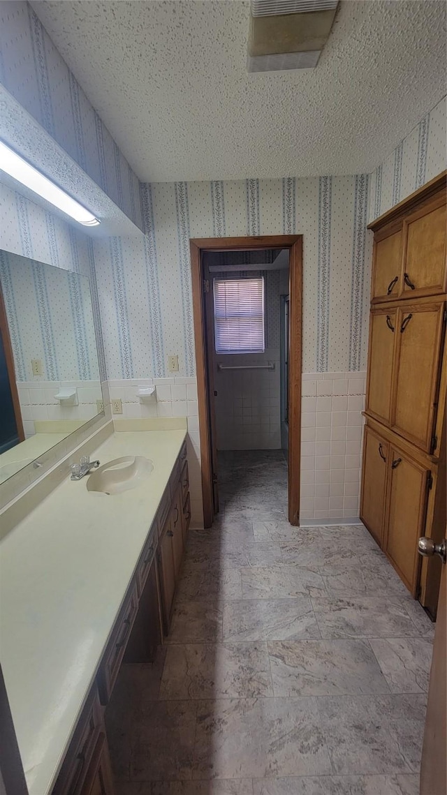 bathroom with vanity and a textured ceiling