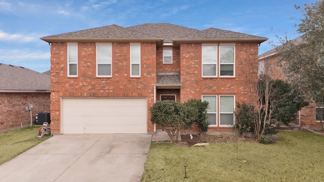 view of front of home featuring driveway, a shingled roof, an attached garage, central AC, and a front yard