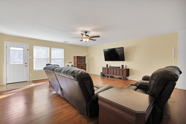 living room featuring ceiling fan and hardwood / wood-style flooring