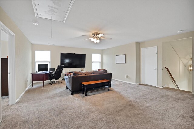 bedroom with ceiling fan, a nursery area, and light carpet