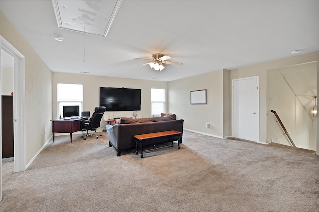 living room with attic access, light colored carpet, baseboards, and a ceiling fan