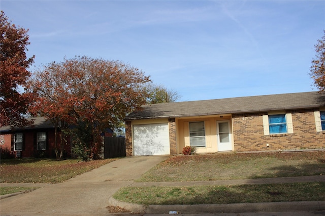 single story home featuring a garage and a front lawn