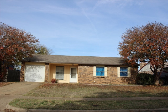 single story home featuring a front yard and a garage