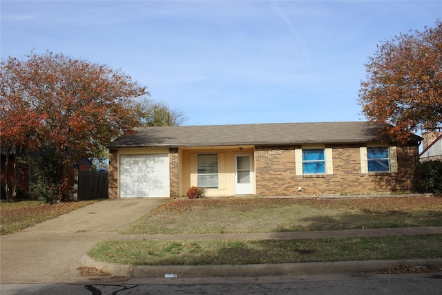 ranch-style house featuring a front yard and a garage