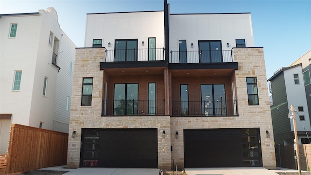 view of front of property featuring a garage and a balcony