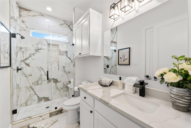 bathroom with vanity, toilet, and a shower with door