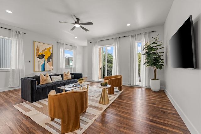 living room featuring ceiling fan and wood-type flooring