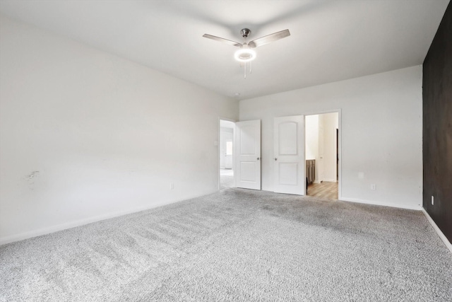 unfurnished bedroom featuring ceiling fan and light carpet