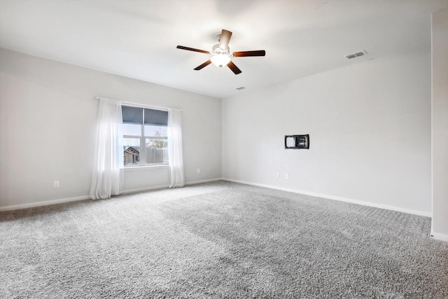 spare room featuring ceiling fan and carpet