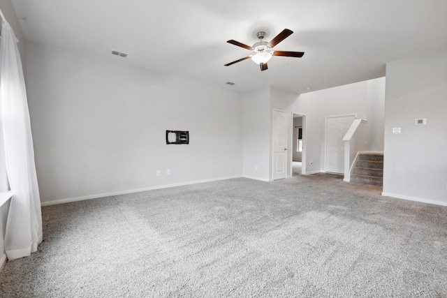 carpeted spare room with ceiling fan