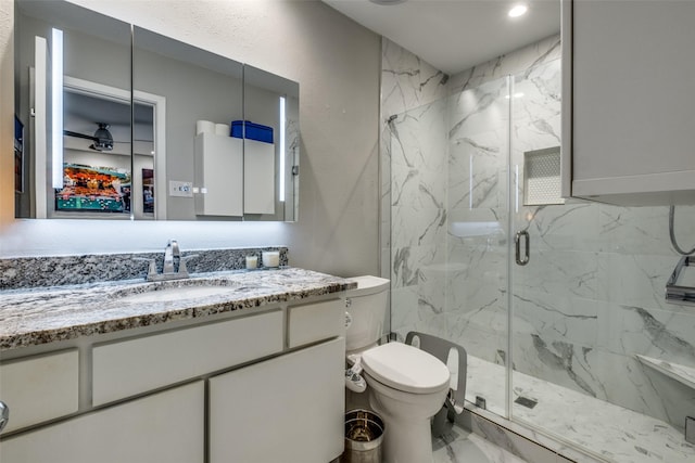 bathroom with vanity, toilet, and a shower with shower door