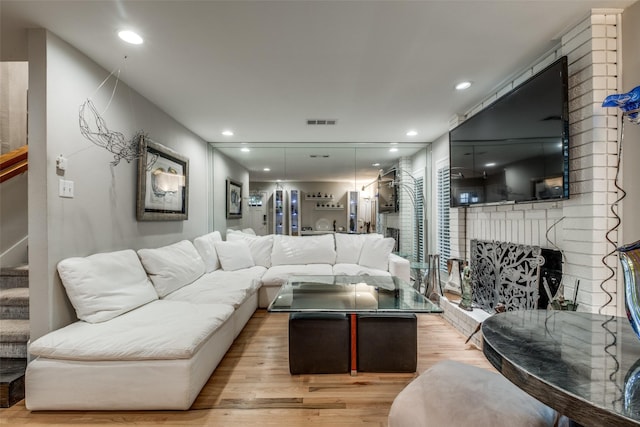 living room with a fireplace and light hardwood / wood-style floors