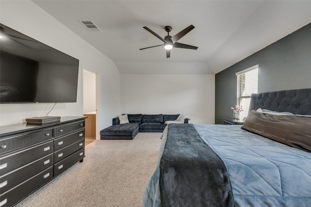 bedroom featuring ceiling fan, vaulted ceiling, carpet floors, and ensuite bath