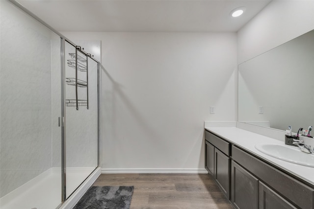 bathroom featuring vanity, hardwood / wood-style flooring, and walk in shower