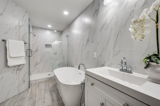 bathroom with vanity, tile walls, and plus walk in shower