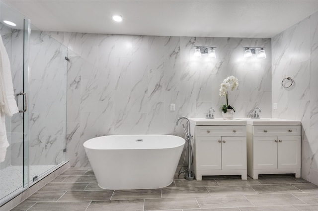 bathroom featuring vanity, tile walls, and plus walk in shower