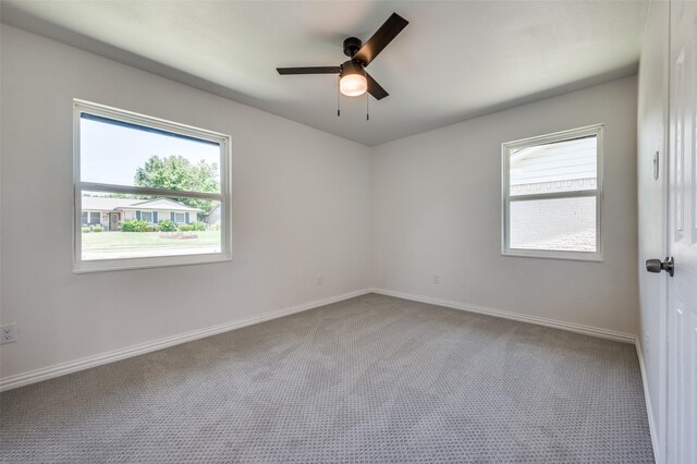 spare room with ceiling fan and carpet floors