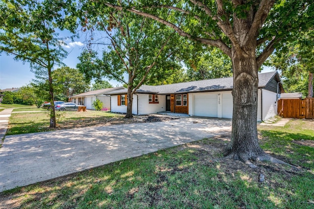 ranch-style house featuring a garage and a front yard