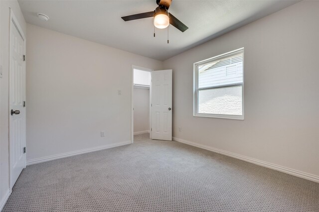 unfurnished bedroom with ceiling fan and light colored carpet