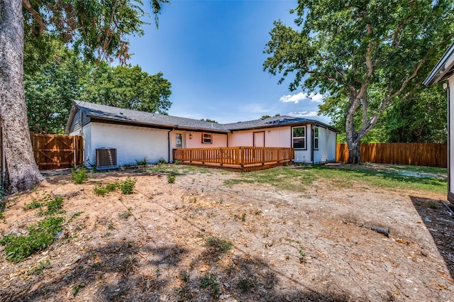 back of house featuring a deck and cooling unit