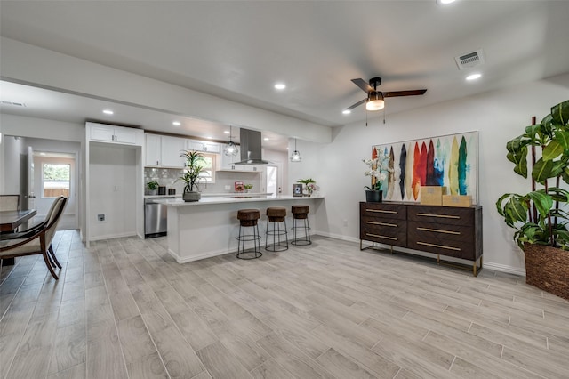 kitchen featuring light hardwood / wood-style flooring, white cabinetry, and exhaust hood